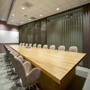Within a meeting room with curtains in front of glass partition walls of QbiQ