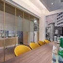 Meeting room with industrial look glass wall in gold colored frame