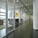 Corridor with double glass partition wall and framed doors