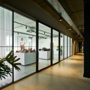 Glass partition with vertical stands and sliding doors