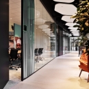 Office with circular-setting of a single glass partition at The Best Place Philips, the Netherlands.