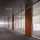 Office corridor with single glass partition walls