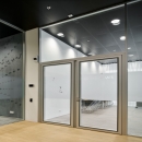 Double doors in a 4 meter high glass partition