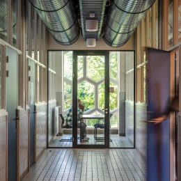 Hallway with glass partitions and door at the end
