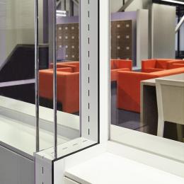 Double glass office wall with acoustic slots between the glass