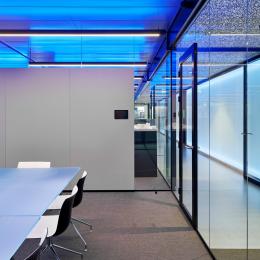Fire resistant glass partition, dividing two offices.