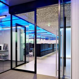 Aluminum framed pivoting door with glass at The Flow Houthavens Amsterdam.