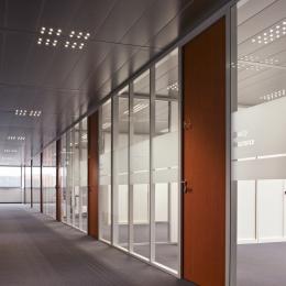 Office corridor with single glass partition walls