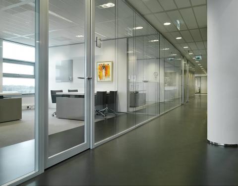 Corridor with double glass partition wall and framed doors