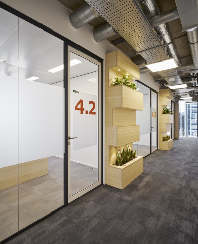 Corridor / office dividing partitions wall made of acoustic laminated single glass and a framed door.