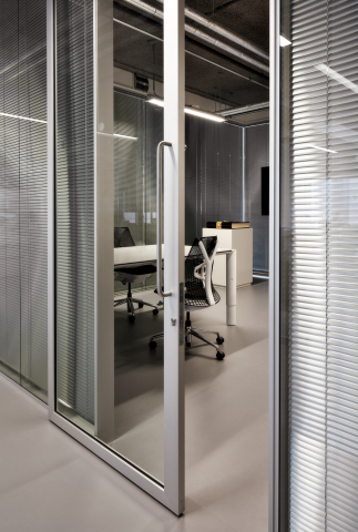 Meeting room with closed blinds and sliding door of QbiQ