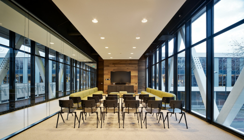 Within a meeting room with glass partition walls of QbiQ