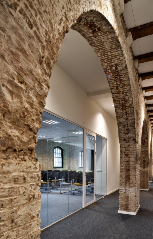 Modern glass wall combined with old stone walls