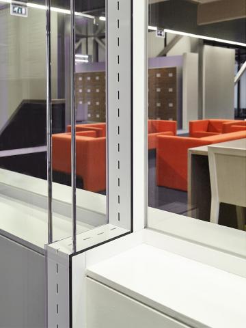 Double glass office wall with acoustic slots between the glass