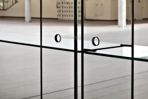 Full glass cabinet against an IQ Single partition wall